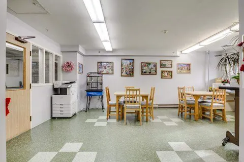 Shared kitchenette with wooden tables and chairs