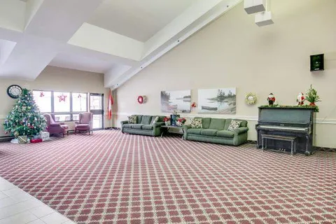Shared lounge with sofas, piano and seasonal decorations