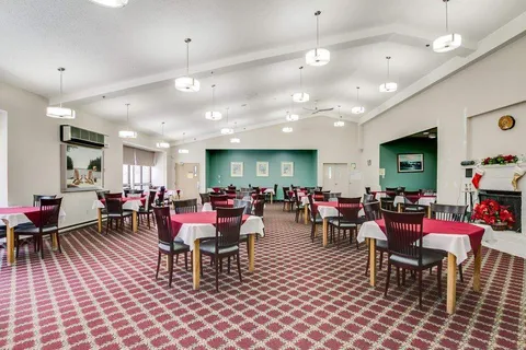 Dining room with tables, pink cloths and green wall panels