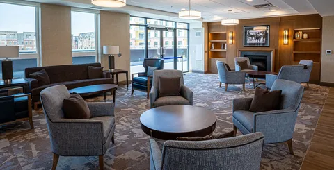 Lounge seating arranged beside a fireplace.