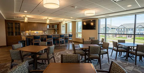 Dining area with tables, chairs and a counter.
