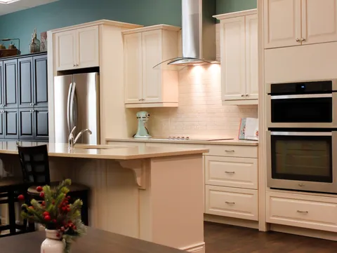Communal kitchen with white cabinets, an island and built-in appliances.