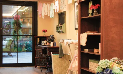Display shelves beside café seating and atrium windows.