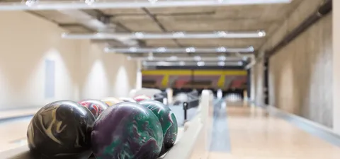 Bowling lane with three bowling balls in the foreground