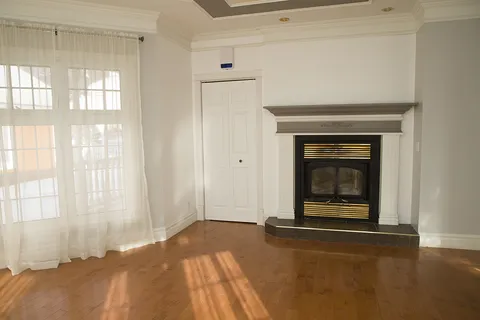 Furnished sitting room with a stone fireplace.