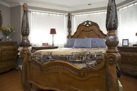 Bedroom with a bed, dresser and window.
