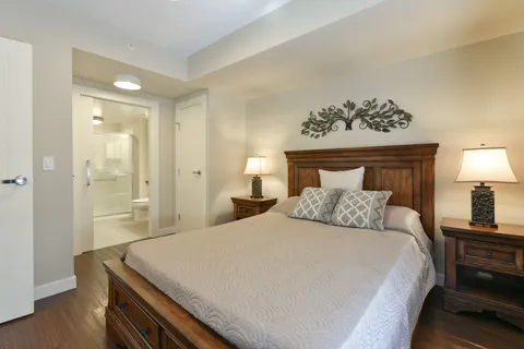 Bedroom with bedside tables and an adjoining bathroom