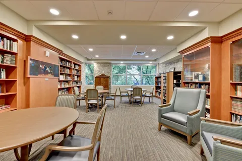 Library with bookshelves, round tables and seating