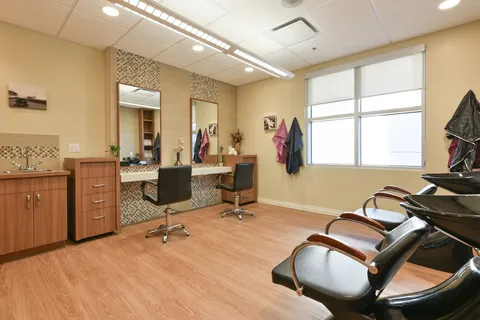 Salon with styling chairs, mirrors and wooden cabinets