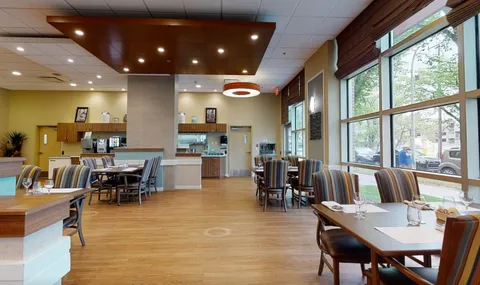 Dining area with wooden tables beside large windows
