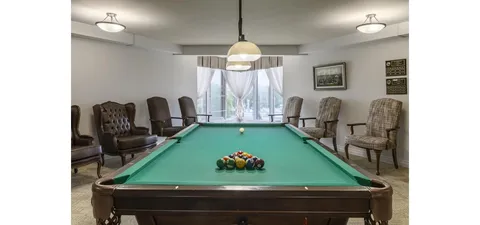 Games room with a pool table and chairs