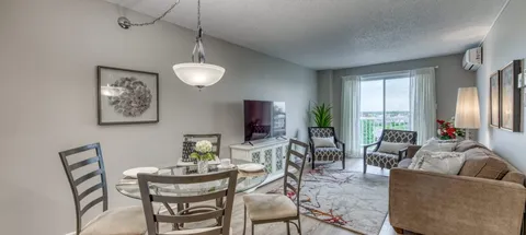 Suite living and dining area beside large windows