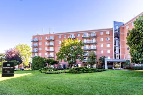Residence exterior beside landscaped lawns and mature trees