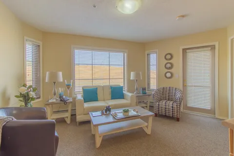 Suite living room with sofas, a coffee table and windows.