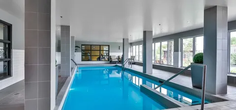 Indoor swimming pool with windows and handrails