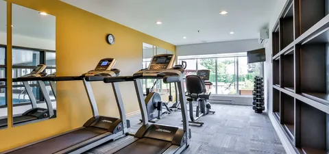 Fitness room with treadmills, mirrors and exercise equipment