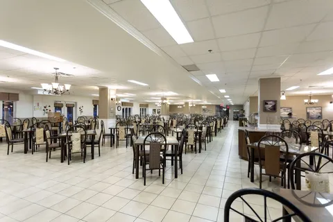 Dining room with rows of tables and chairs.