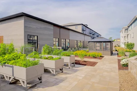 Garden walkway with raised vegetable beds beside the building.