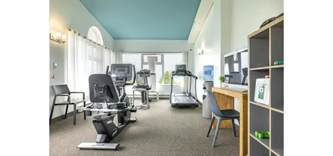 Fitness room with exercise machines and a recumbent bike.