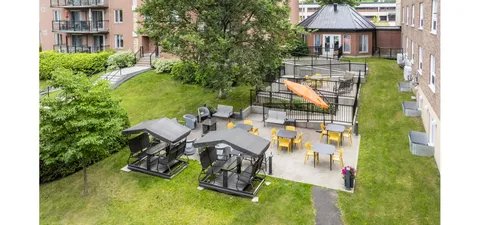 Courtyard with covered swings, garden beds and a gazebo.