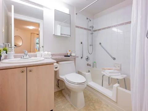 Suite bathroom with shower, toilet and vanity.