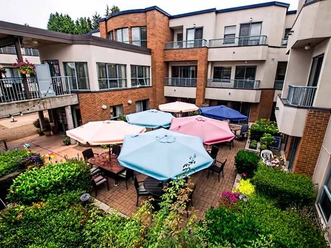 Courtyard patio with tables and colourful umbrellas.