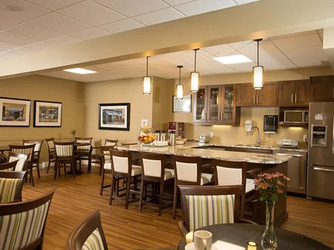 Dining and coffee area with high tables and a serving counter.