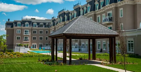 Gazebo and planted grounds beside the residence building.