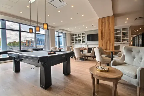 Lounge with a billiards table, armchairs and tables.