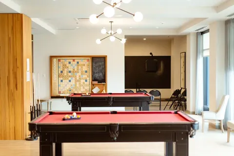 Games room with two red billiards tables.