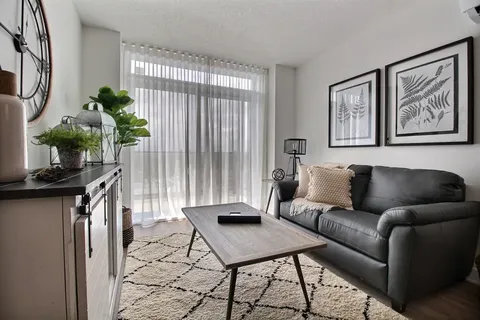 Suite sitting room with a sofa, coffee table and patio doors.