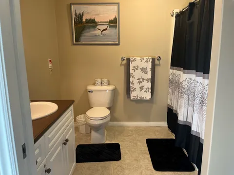 Bathroom with a sink, toilet and shower enclosure.