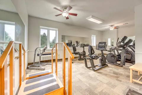 Exercise room with stationary bicycles, training steps and parallel bars