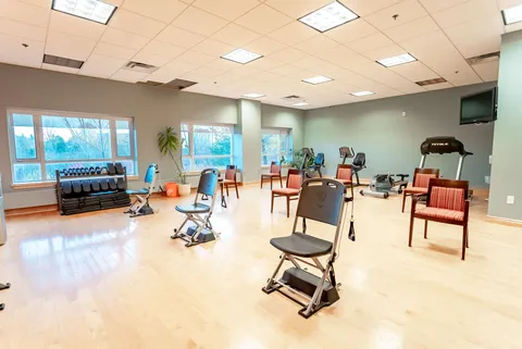 Exercise room with weights, fitness equipment and chairs