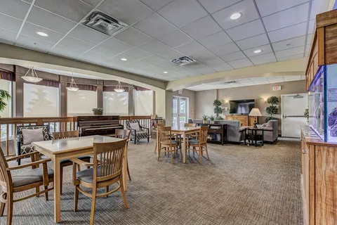 Bistro seating with tables, television and large windows.