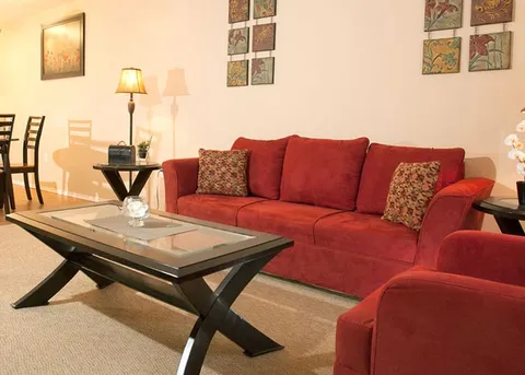 Suite sitting area with red sofas and a coffee table.