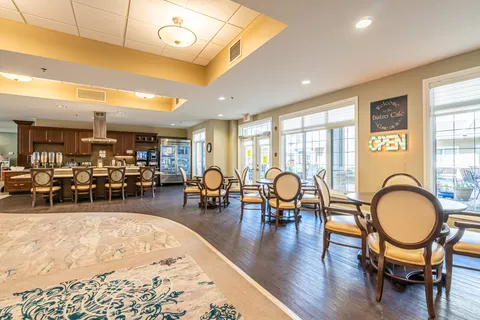 Dining area with round tables, upholstered chairs and a counter