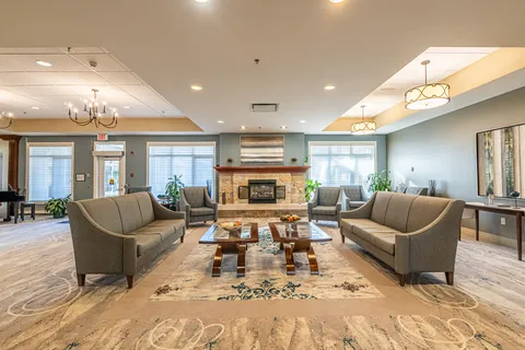 Lounge with sofas, armchairs, coffee tables and a stone fireplace