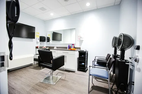 Hair salon with styling chairs, mirrors and hooded hair dryers