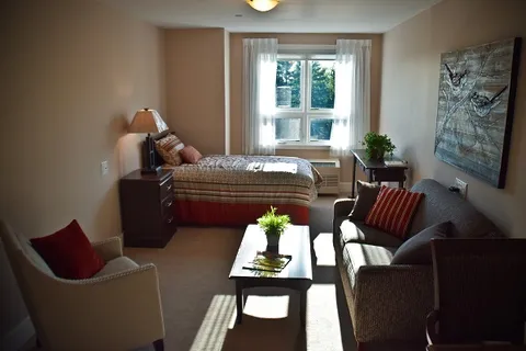 Room with a bed, sofa, armchair and coffee table