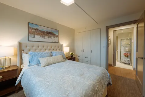 Bedroom with a double bed, blue bedding and an adjoining bathroom
