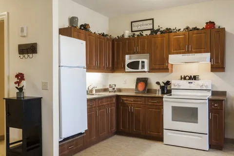 Kitchen with a stove, refrigerator and cabinets