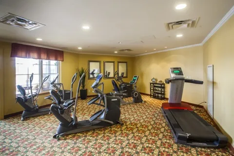 Exercise room with fitness equipment and large windows