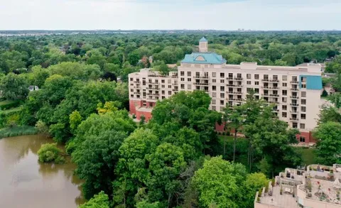 Aerial view of the residence surrounded by trees near the harbour.