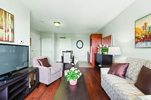 Sitting area with a sofa, armchair, television and coffee table