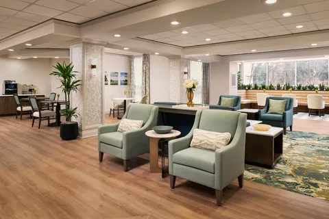 Lobby lounge with armchairs beside large windows