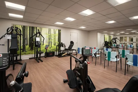 Fitness room with exercise equipment and chairs