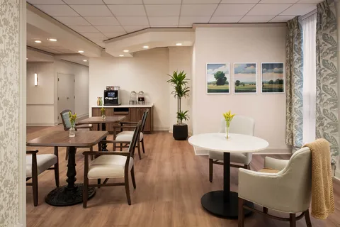 Seating area with tables beside a coffee counter