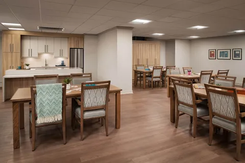 Activity room with tables and a communal kitchen