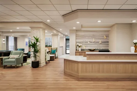 Reception desk beside a lounge and wooden flooring